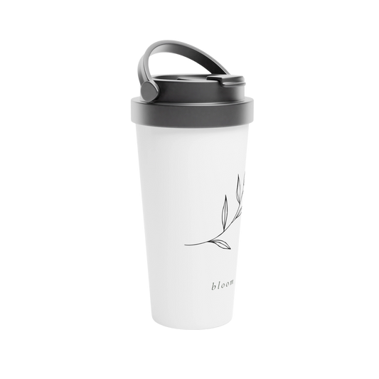 A side picture of a white travel tumbler featuring a minimalist black leaf branch illustration and the word 'bloom' printed near the bottom.