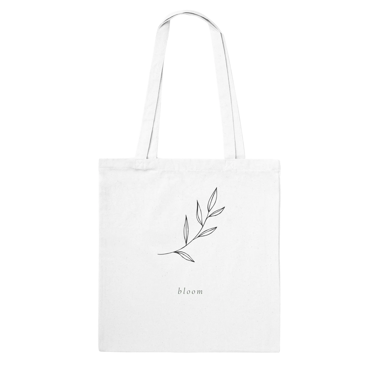 Tote bag with a delicate leafy branch design en the text 'bloom' beneath it.