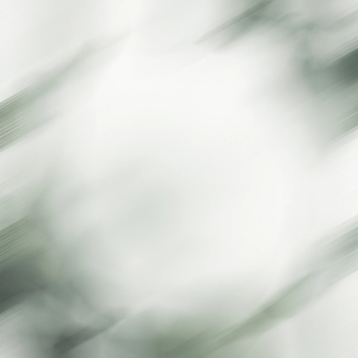 An abstract, blurred background with soft white and light gray tones and faint green-gray streaks, resembling motion-blur photography.